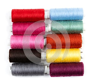 Coils of colored thread on a white background