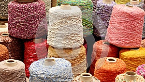 Coils and spools of fine colored wool thread for the creation