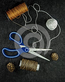 Coils of thread and tangle. Scissors and needle with thread