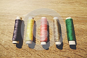 The coils of threads put on wooden table