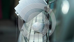 coils of white cotton threads on plastic racks. close up