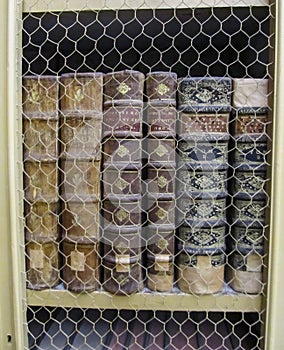 Ancient books in a row protected by a wire screen in a library in Portugal