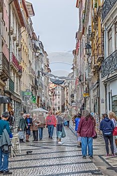 View at the Ferreira Borges Street, Downtown street in Coimbra city, persons and classic buildings