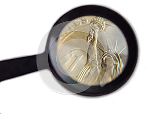 Coin 1 dollar under a magnifying glass