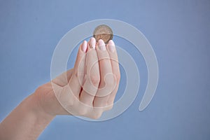 Coin 2 euros in female fingers