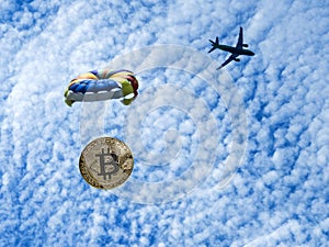 Coin bitcoin is flying on a parachute from the plane. Airdrop token.