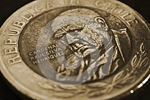 Coin of 500 Chilean pesos ÃÂlose-up. Peso of Chile. News about economy or banking. Loan and credit. Wages and money. Dark brown photo