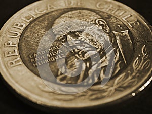Coin of 500 Chilean pesos ÃÂloseup. Peso of Chile. News about economy or money. Loan and credit. Interest and inflation. Dark photo