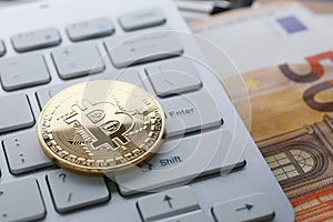 Coin crypto currency bitcoin lies on the keyboard