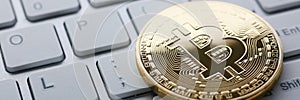 Coin crypto currency bitcoin lies on the keyboard
