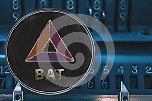 Coin cryptocurrency BAT against the numbers of the arithmometer.