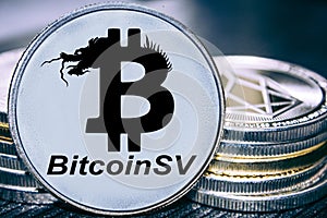 Coin cryptocurrency Bitcoin SV on the background of a stack of coins. Satoshi vision