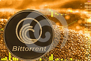 Coin cryptocurrency bittorrent btt on golden chart. photo