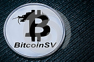 Coin cryptocurrency BSV on a grey background. The bitcoin SV