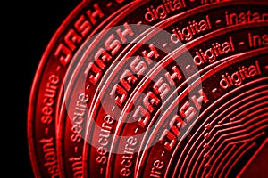 The coin cryptocurrency Dash closeup on red black background.
