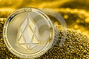 Coin cryptocurrency EOS on golden background