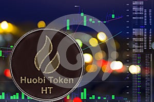 Coin cryptocurrency huobi token ht on night city background and chart.