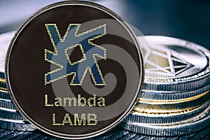 Coin cryptocurrency LAMB Lambda on the background of a stack of coins.