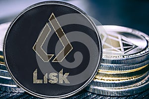 Coin cryptocurrency Lisk basic attention token on the background