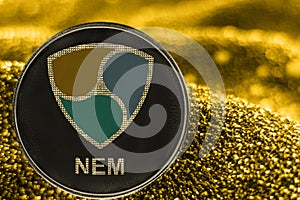 Coin cryptocurrency NEM on golden background. crypto XEM token.