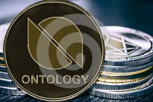 Coin cryptocurrency Ontology on the background of a stack of coins. ONT photo