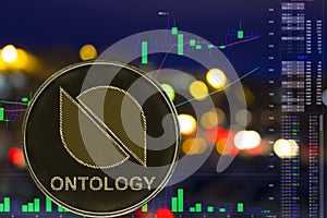 Coin cryptocurrency Ontology ONT on night city background and chart.