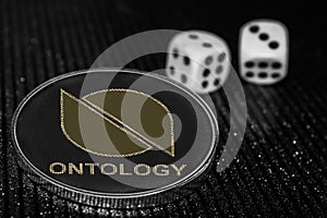 Coin cryptocurrency Ontology and rolling dice. ONT photo
