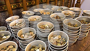 Coin in the donation bowl and bronze coin