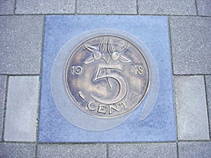 Coin of five cents in pavement