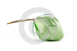 Coin folding with Ribbon is shaped a green fruit on white background for ordination scatter ceremony of buddhism.