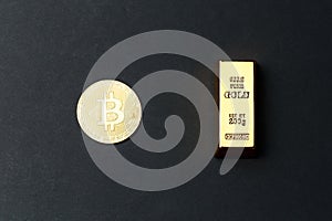 A coin of gold bitcoin next to a gold bar. Bitcoin Conservation. Cryptocurrency. Close-up. Virtual money. Copy space