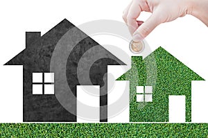 Coin Hand holding house icon in nature as symbol of mortgage