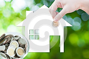 Coin Hand holding house icon in nature as symbol of mortgage,Dream house on nature background