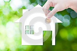 Coin Hand holding house icon in nature as symbol of mortgage,Dream house on nature background