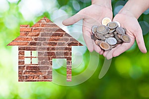 Coin Hand holding house icon in nature as symbol of mortgage,Dream house on nature background