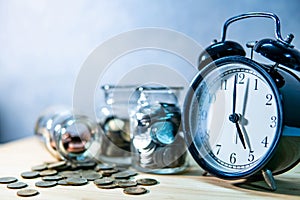 Coin jars and clock. Saving money for retirement