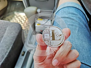 Coin Litecoin in the hands of a man blockchain-technology photo