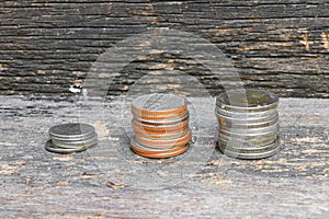 Coin money stacks on wooden floor background