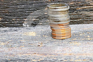 Coin money stacks on wooden floor background