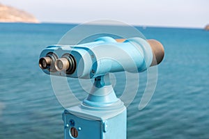 Coin operated binocular looking to the sea and Spinalonga Island on Crete, Greece