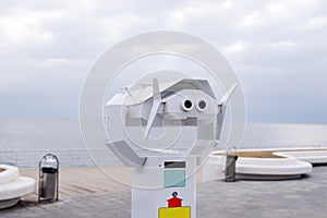 Coin Operated Binocular viewer next to the waterside promenade in Odessa looking out to the sea view. Landscape with beautiful clo