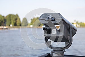 Coin operated binoculars on the edge of a river