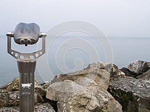 coin operated binoculars looking out in garda lake