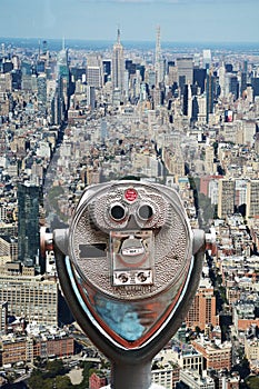 Coin operated binoculars on Top of the Rock, against Empire State Building â€“ Manhattan