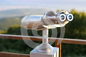 Coin-operated binoculars on a vantage point overlooking the city photo