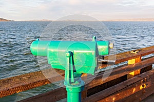 Coin operated monocular telescope for distant viewing on the pier