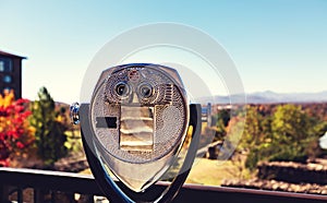 Coin-operated viewer looking out over an autumn landscape