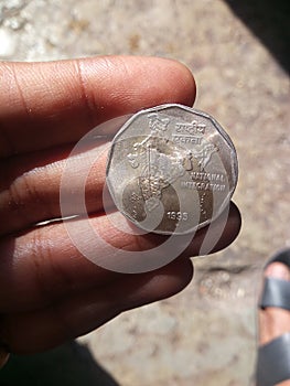 Coin placed on fingers Indian currency 2 Rupees coin year 1995