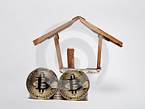 Coin stack,bitcoin and house miniature isolated on white