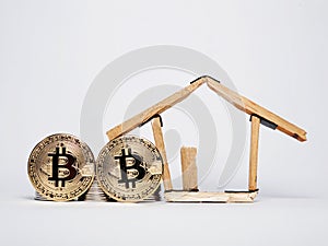 Coin stack, ,bitcoin and house miniature isolated on white